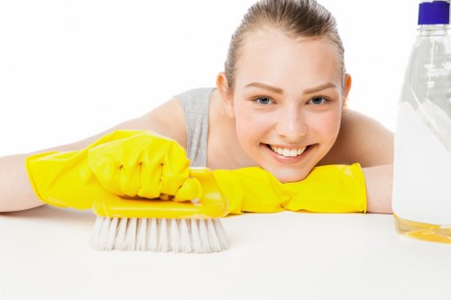 Professional cleaner handling garments at Arkley Cleaners